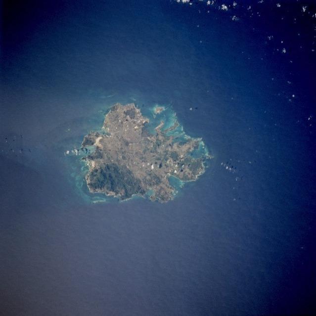The island of Antigua as seen from space. St. John's, the country's capital, is located along the northwest coast, adjacent to one of the island's many natural harbors. More than half of the country's population lives in the St. John's area. Image courtesy of NASA.