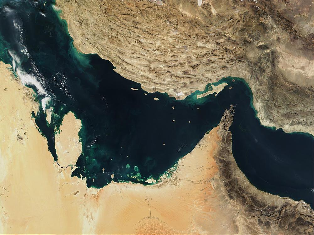 The Persian Gulf (left) and the Gulf of Oman (right) were once the site of a rift, an area where two plates of the earth's crust pulled apart from each other. The Indian Ocean filled in the widening gap between the two plates. Over time, the process reversed, and about 20 million years ago, the gulfs began to close up. The ongoing collision of the two continental plates resulted in Iran's mountainous terrain (top) and its periodic earthquakes.
Several Gulf States are visible across the eastern Arabian Peninsula that makes up the lower part of the image. In addition to Saudi Arabia across the bottom, the islands of Bahrain in the left center lie next to the prominent peninsula that makes up Qatar. Further to the right are various offshore islands of the United Arab Emirates; most of the darker area to the right makes up Oman. Photo courtesy of NASA.