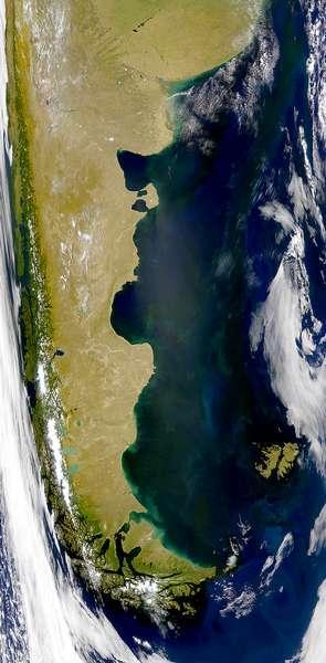 Summertime (January) satellite image of the southern cone of South America showing green vegetation on the Andes Mountains of south Chile, the Patagonian plains of south Argentina, and the Falkland Islands. The bright green areas are algal blooms. Photo courtesy of NASA.