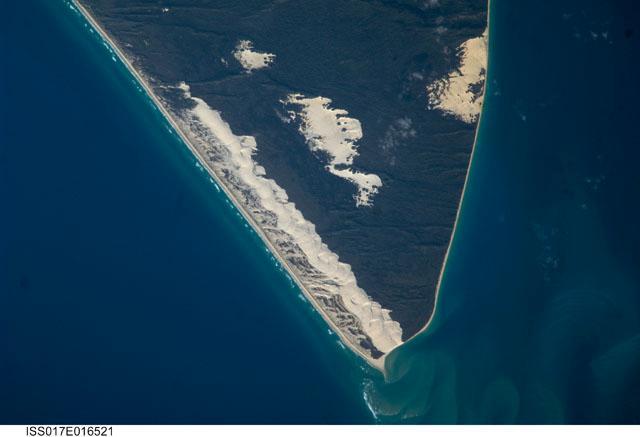 Sandy Cape and part of Fraser Island may be seen in this image photographed from the International Space Station. Fraser Island, the world's largest sand island, includes Great Sandy National Park and is located along the coastline of Queensland. The island was designated a World Heritage site in 1992, in part due to its outstanding preservation of geological processes related to sand dune formation. Image courtesy of NASA.