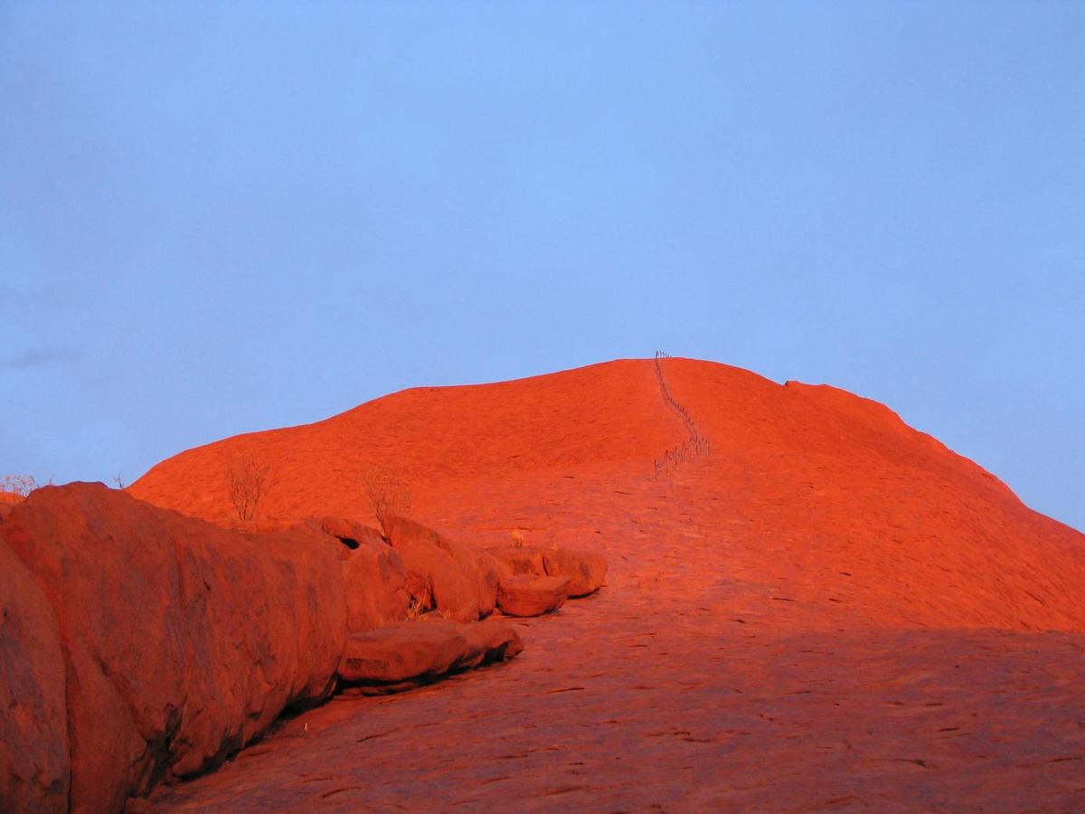Ayers Rock changes colors throughout the day; this is its base at sunset.