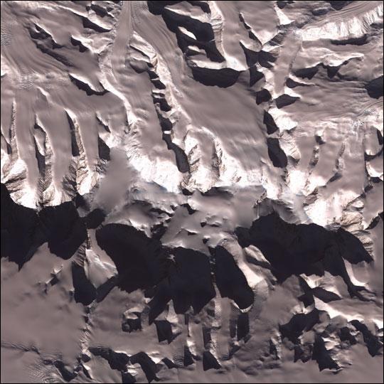Vinson Massif is the tallest mountain in Antarctica. Its peak reaches 4,897 m (16,067 ft), though the mountain itself is a large raised feature around 21 km (13 mi) long and 13 km (8 mi) wide, dominating the Sentinel Range of the Ellesworth Mountains in which it is located. Image courtesy of NASA.