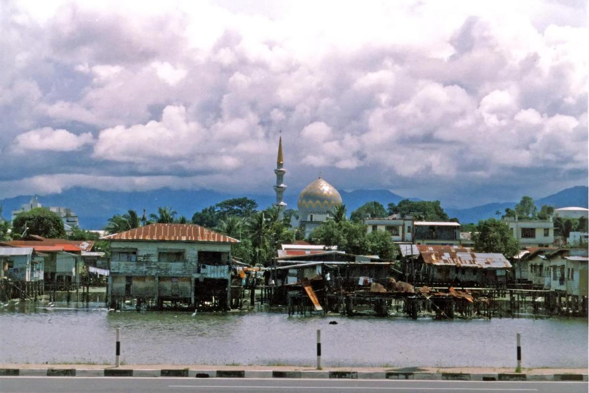 Another view of the water village of Kampong Ayer; the Sultan Omar Ali Saifuddin Mosque looms in the background.