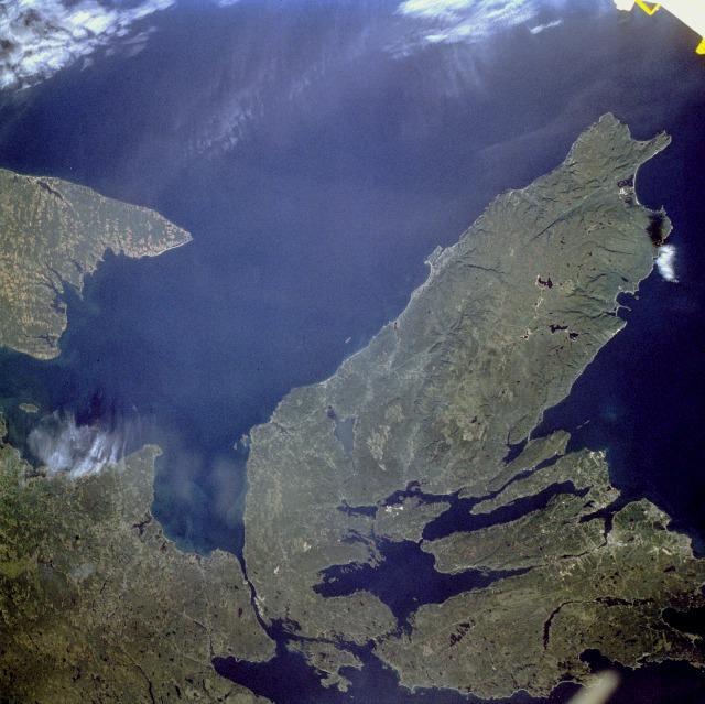 The Canadian maritime province of Nova Scotia can be divided into two separate regions - Cape Breton Island (on the right) and much larger, peninsular mainland Nova Scotia (lower left). Cape Breton Island is joined to the mainland by a causeway and a railroad spanning the narrow Strait of Canso. St. George's Bay is the small bay west of the causeway, and the Northumberland Strait separates Cape Breton Island from the eastern end of Prince Edward Island, another maritime province of Canada (visible along the west margin of the photograph). Photo courtesy of NASA.