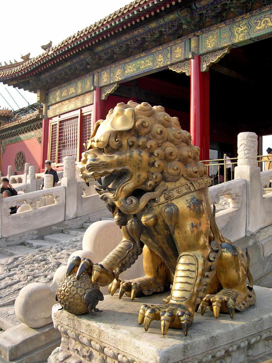 A gilded lion sits before the Palace of Tranquil Longevity in the Inner Court of the Hall of Supreme Harmony in the Forbidden City.