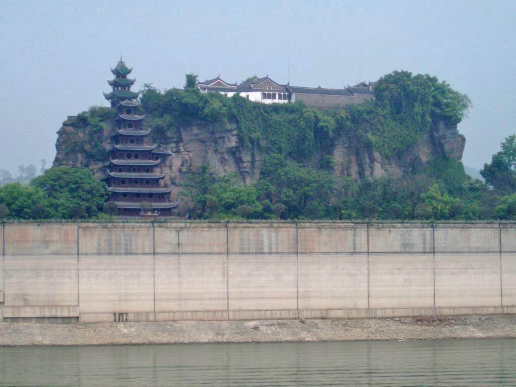 Shibaozhai is a steep, rocky, and craggy hill on the bank of the Yangtze River, in Zhong county, Chongqing. A temple at the crest of the 220 m (722 ft) hill was built in the 18th century. A nine-story wooden pagoda was constructed in the 1819 to aid pilgrims in getting to the top of the hill. In 1956, three more stories were added. A coffer dam protects the site from higher river waters - the result of the Three Gorges Dam.