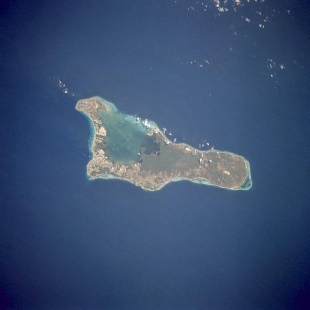 Grand Cayman is a low-lying, limestone island located on top of a submarine ridge. The city of George Town, the capital and chief port of the Cayman Islands, may be seen at the southwest end of the island. Grand Cayman's 7-mile beach is on the western side of the island. With exotic coral reefs off its shores, Grand Cayman is a mecca for divers. Image courtesy of NASA.