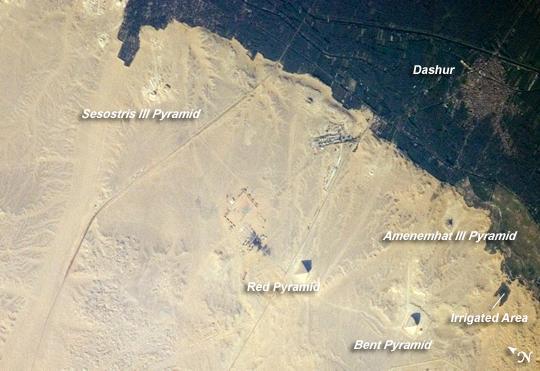 The pyramids at Dashur, about 40 km (25 mi) south of Cairo. The gray-brown built-up area of the village of Dashur in the upper right is surrounded by the green agricultural land of the Nile Delta, which forms a distinct boundary with the tan desert to the west. It is in the desert that the monuments of the ancient rulers of Egypt are found. Click on photo for higher resolution. Image courtesy of NASA.