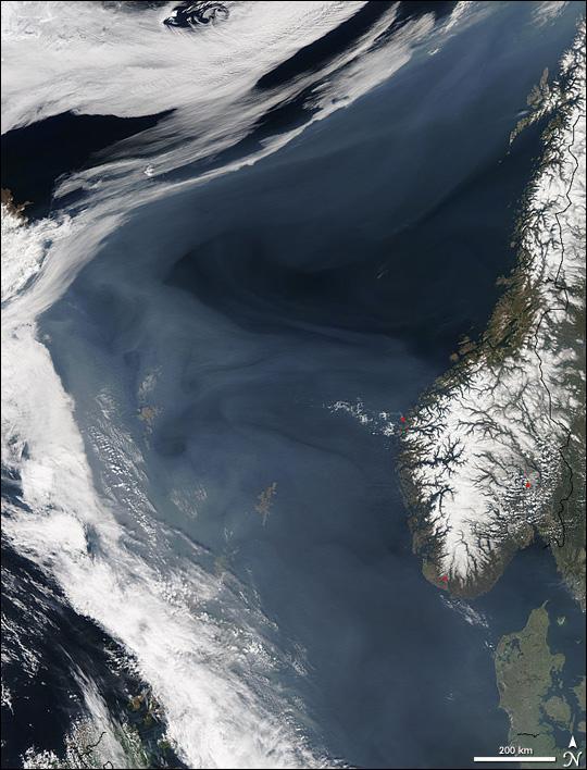 Grayish white over the deep blue Norwegian Sea, a thick cloud of smoke drifts north off the western coast of Norway in this image, taken on 7 May 2006, by NASA's Aqua satellite. The smoke is coming from hundreds of fires burning in western Russia, most of which are probably agricultural fires. By the time this image was taken, smoke had lingered over the Norwegian Sea for more than a week as the fires continued to burn. In this image, hazy skies extend from Denmark, lower right, west to Iceland, upper left. The densest of the smoke hangs over the Shetland Islands (lower center) and the Faroe Islands (left center). The northern shores of Great Britain are in the lower left corner of the image. Photo courtesy of NASA.