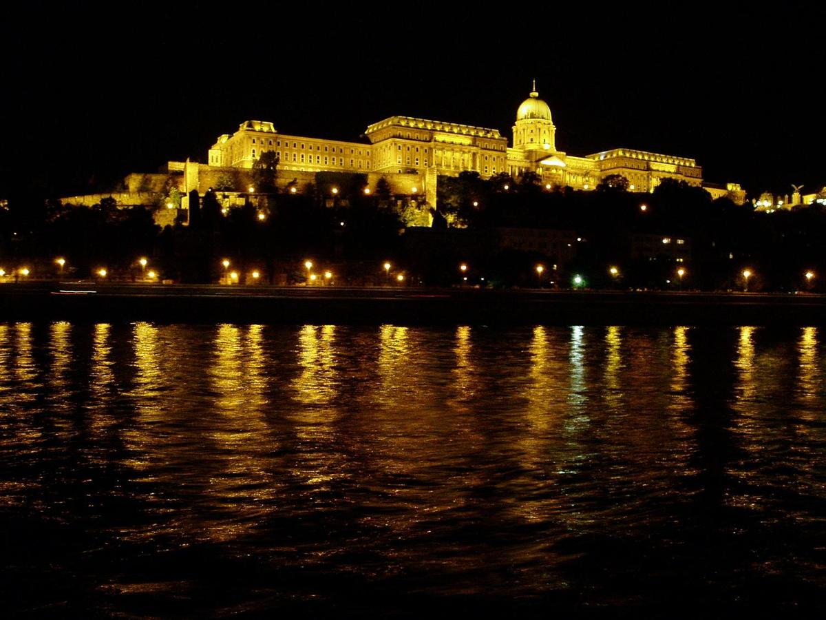 An night-time view of Buda Castle as seen from along the Danube in Pest.