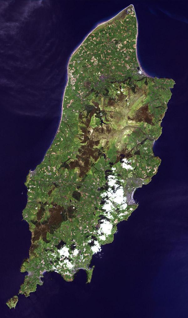 The Isle of Man is a self-governing British Crown Dependency in the Irish Sea between Great Britain and Ireland. The island is not part of the UK, though the head of state is Queen Elizabeth II. Inhabited since 6500 BC, the island was influenced by Gaelic culture, settled by the Norse, was part of Scotland, and came under the feudal overlordship of the English Crown in 1399. The island's parliament, Tynwald, is one of the oldest ruling bodies in the world, possibly dating to the 10th century. The satellite image, acquired 1 May 2001, covers an area of about 30x50 km (19x31 mi). Photo courtesy of NASA.