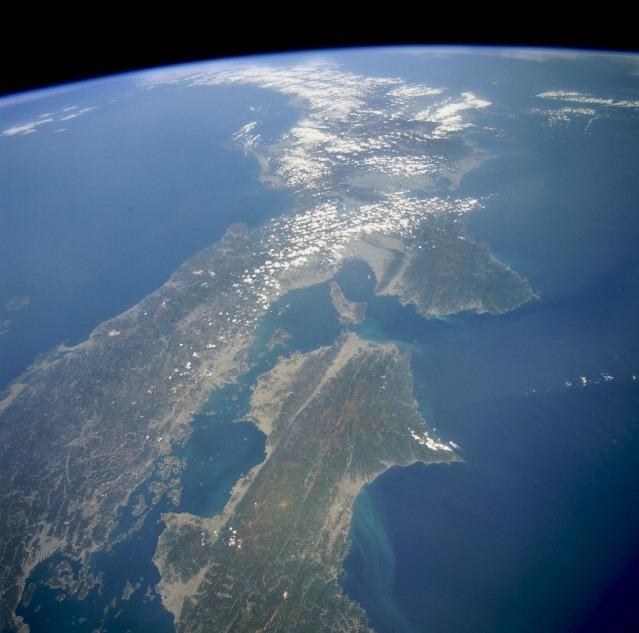 This high-oblique, northeast-looking space shuttle photograph captures a portion of Southern Honshu Island and Shikoku Island of Japan. The darker areas show volcanic, mountainous terrain that comprises more than 80 percent of Japan; the lighter, more highly reflective areas of the coastal plains and valleys are urban and agricultural areas. Separated by the Seto Inland Sea are Shikoku Island to the south and the Osaka-Kobe industrial metroplex on Honshu Island to the north. Photo courtesy of NASA.