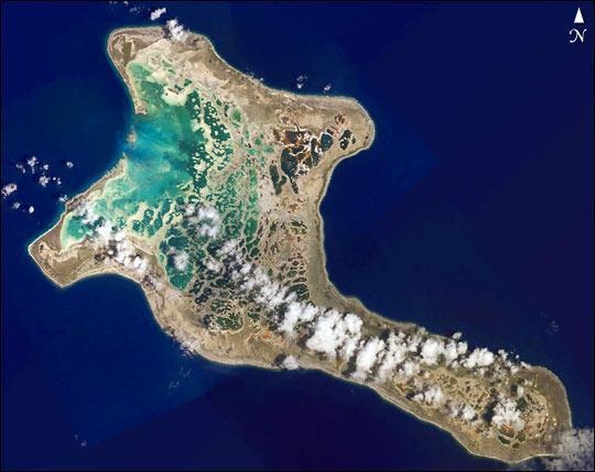 Pronounced "Ki-ris-mas," Kiritimati Island has a large infilled lagoon that gives it the largest land area of any atoll in the world. Captain Cook named the atoll Christmas Island when he arrived on Christmas Eve in 1777. Used for nuclear testing in the 1950s and 1960s, the island is now valued for its marine and wildlife resources. It is particularly important as a seabird nesting site, with an estimated 6 million birds using or breeding on the island, including several million Sooty Terns. Rainfall on Kiritimati is linked to El Nino patterns, with long droughts experienced between the wetter El Nino years. This image is a mosaic of four digital photographs taken on 16 January 2002 from the Space Station. Photo courtesy of NASA.