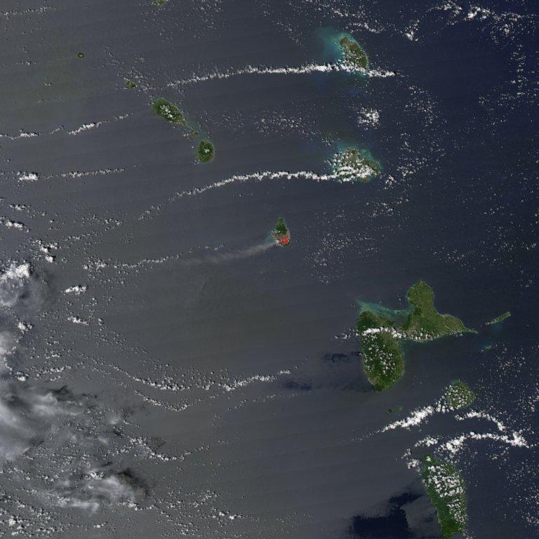 The Soufriere Hills Volcano on the island of Montserrat produced a plume of volcanic ash and/or steam on 1 October 2006, part of a continuing pattern of intermittent eruptions. In this image, the island of Montserrat shows an area outlined in red - the thermal hotspot. The plume of volcanic ash blows westward over the Caribbean Sea, gradually dissipating as it moves away. No recorded eruptions of the volcano occurred before 1995, but since then, volcanic ash emissions have posed recurring health hazards for Montserrat's residents. Photo courtesy of NASA.