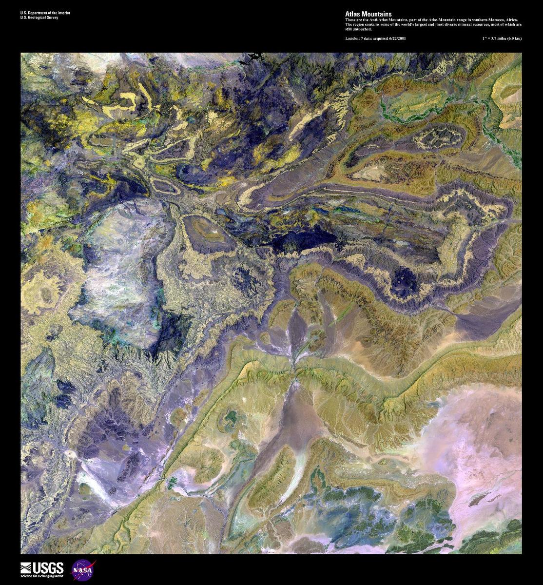 This enhanced satellite image shows the Anti-Atlas Mountains, part of the Atlas Mountain range in southern Morocco. The Anti-Atlas Mountains form a border between the Atlantic Ocean and the Sahara Desert, extending 500 km (310 mi) to their easternmost point, the 3,304 m (10,835 ft) peak of Djebel Sarho. The region contains some of the world's largest and most diverse mineral resources including phosphate rock, iron, zinc, copper, antimony, as well as gold and silver, most of which remain untouched. Image courtesy of USGS.