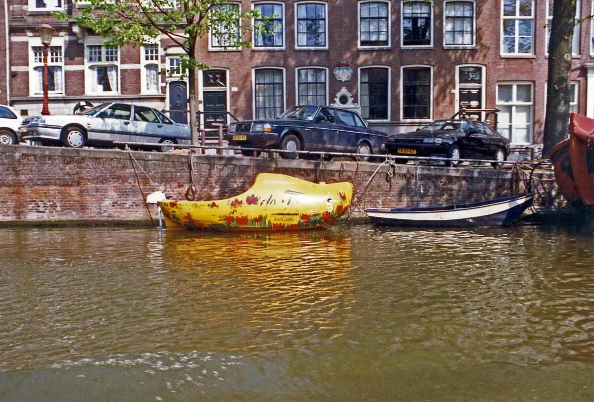 A wooden shoe-shaped boat on an Amsterdam canal. Most of the city's canals were built in the 17th century. The old city center of Amsterdam is the focal point for architectural styles prior the end of the 19th century; outlying areas display more recent architectural styles.