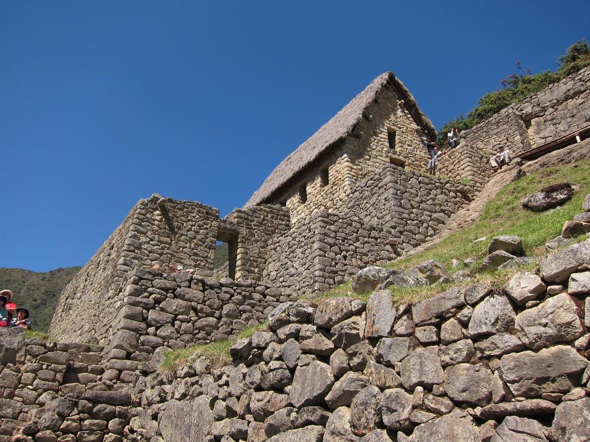 A house at the Machu Picchu ruins with a new thatched roof, modeled after the Inca roof design.