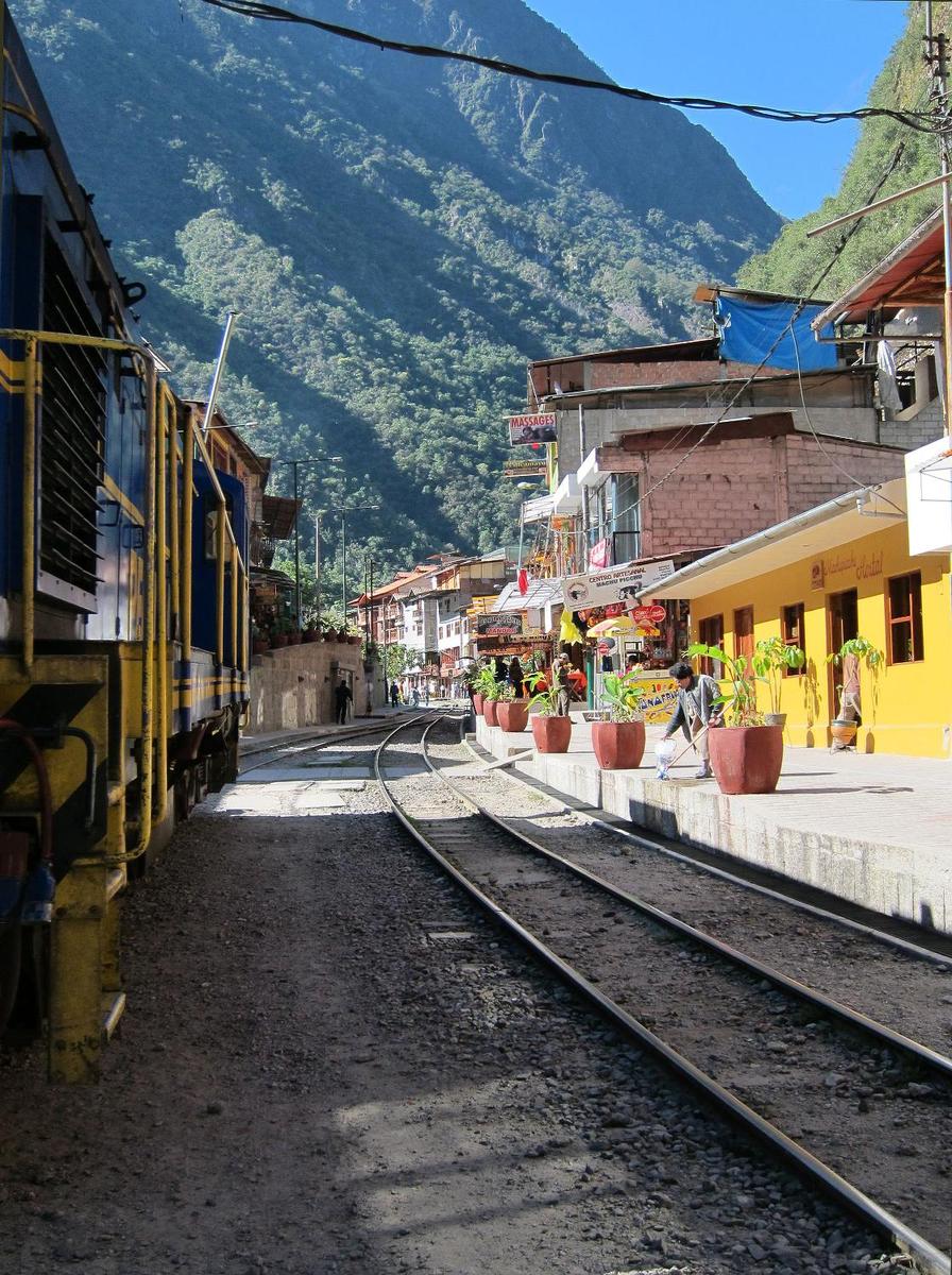A train passing through the center of Aguas Calientes.