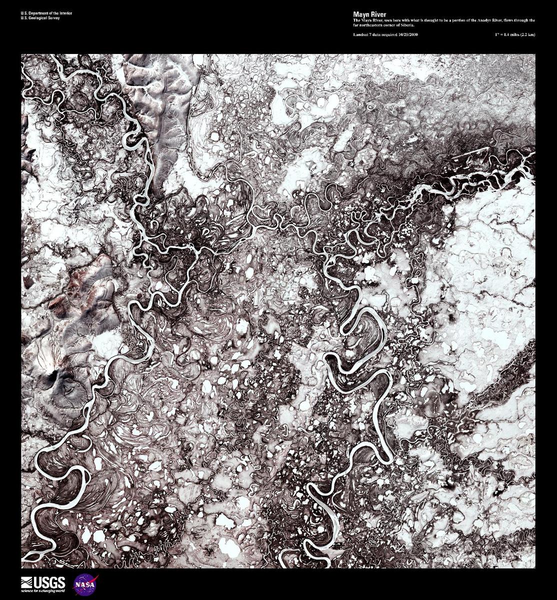 The Mayn River (on the left), seen here in a false color satellite image with a portion of the Anadyr River (on the right), flows through the far northeastern corner of Siberia. Both rivers carry a great deal of sediment and over time have created an amazing number of oxbow lakes. In this forest-tundra zone, both rivers remain frozen for 8 to 9 months out of the year. Image courtesy of USGS.
