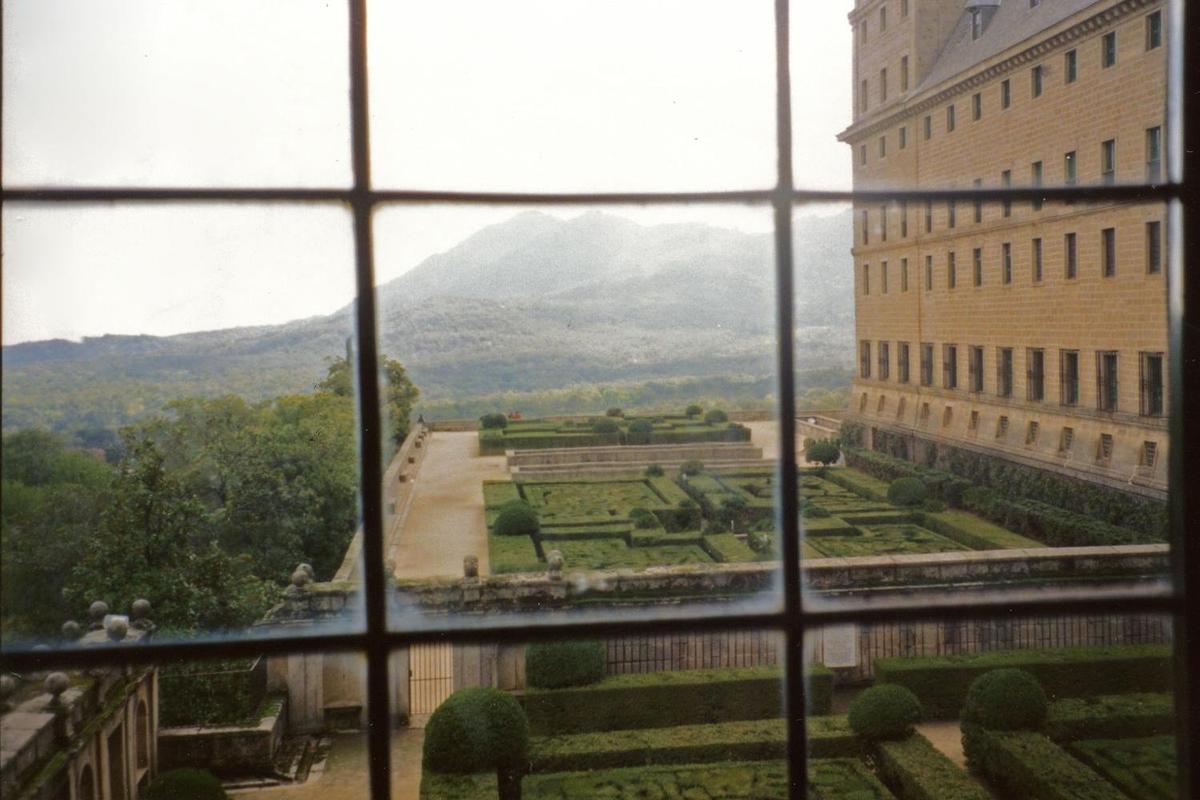 View of the gardens through a window at the El Escorial.
