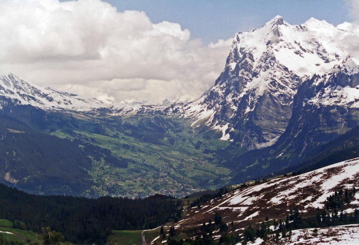 Mount Wetterhorn (3,692 m; 12,110 ft), near Grindelwald, overlooks the upper reaches of an Alpine valley - still snow covered in June.