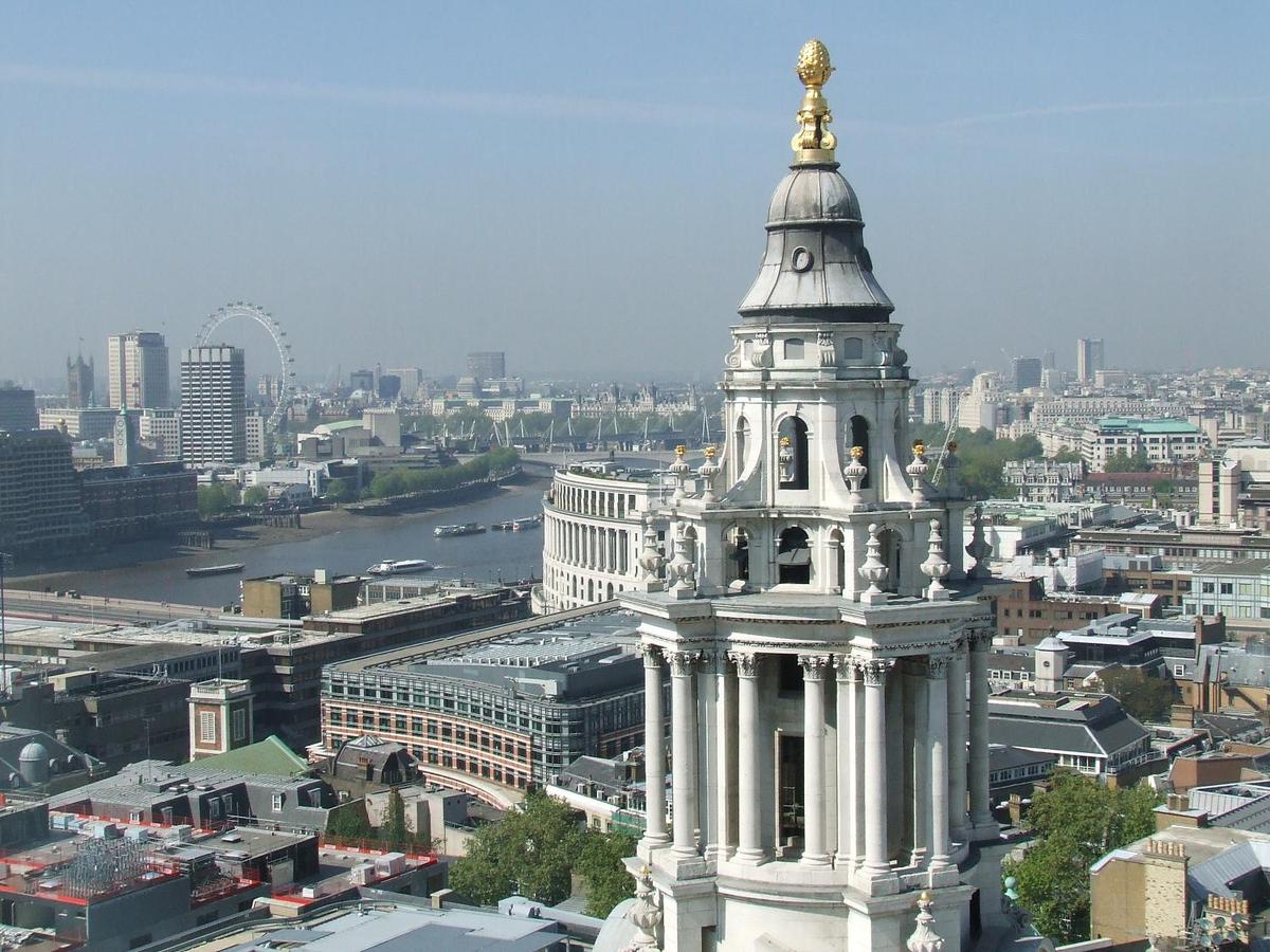 A vista of London from the Golden Gallery, the highest point of the outer dome of St. Paul's Cathedral in London. Some 85 m (280 ft) above the city, this view requires a climb of 530 steps. The large structure on the right is the cathedral's west end clock tower.