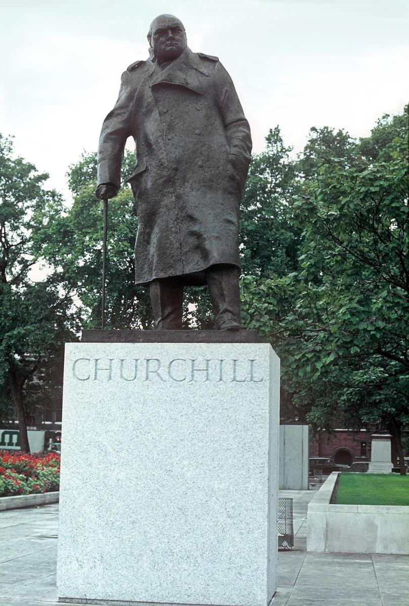 The statue of Winston Churchill on the grounds of the Houses of Parliament building (Westminster Palace) in London.