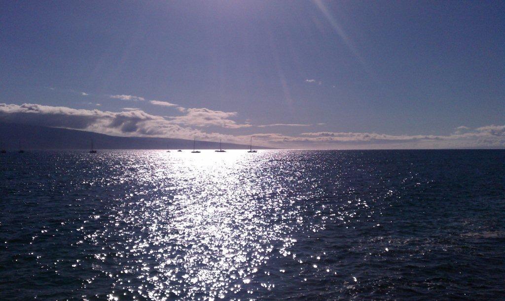 The late afternoon sun sparkles on the channel between Lahaina, Maui and the island of Lanai.