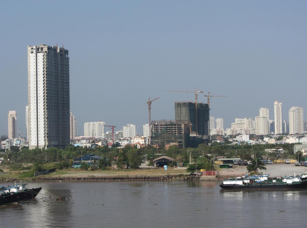 View of Ho Chi Minh City (aka Saigon) from the Saigon River. Saigon is Vietnam's major port and, with 8 million inhabitants, its largest city. It was called Saigon until 1975 when it was renamed Ho Chi Minh City following its capture by North Vietnamese communist forces. Although the city's commercial core is officially called Saigon, the entire city is widely referred to as Saigon even in the North. The city was architecturally influenced by the French during their colonial occupation of Vietnam. Numerous classical Western-style building in the city reflect this, so much so that Saigon was referred to as "The Pearl of the Far East" or "Paris in the Orient." In more recent years, a building boom has transformed the skyline of the city.