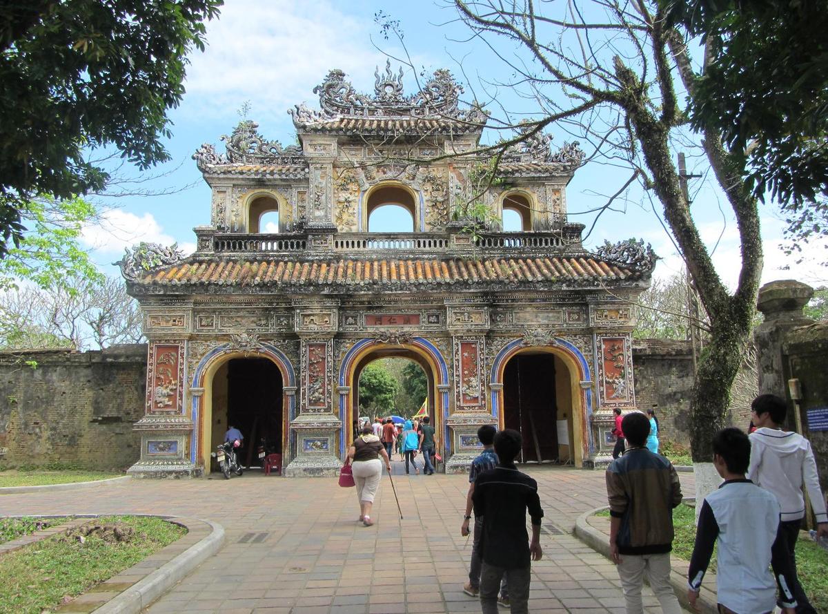 Gate leaving the grounds of the former Imperial City in Hue. Located on the Perfume River in central Vietnam, Hue was the capital of Vietnam from 1802 until 1945. A walled citadel, 2 km by 2 km, as well as a moat, surrounded the city. Inside the citadel was the Imperial City. Many of the buildings of the Imperial City were destroyed during the Vietnam War. Some reconstruction has begun.