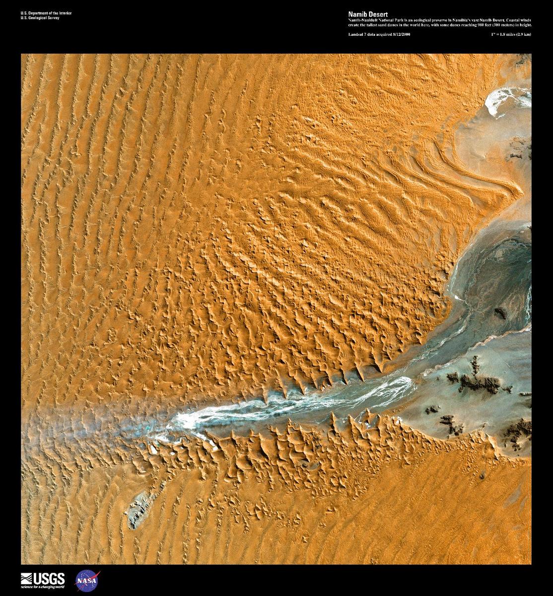 Namib-Naukluft National Park is an ecological preserve - the largest game reserve in Africa - in the vast Namib Desert, a part of which may be seen in this high-resolution satellite image. Due to the orange color of the sand, which develops over time as the iron in the sand is oxidized, the Namib Desert is considered the oldest desert in the world. Coastal winds create the tallest sand dunes in the world here, with some dunes reaching 300 m (980 ft) in height. Image courtesy of USGS.