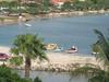 Small, colorful boats moored in a quiet harbor.