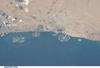 Three man-made archipelagos near Dubai, United Arab Emirates, are featured in this image from the International Space Station (ISS), flying at 350 km (220 mi) above Earth. The municipality of Dubai is the largest city of the Persian Gulf emirate of the same name, and has built a global reputation for large-scale developments and architectural works. Among the most visible of these developments - particularly from the perspective of astronauts onboard the ISS - are three man-made archipelagos. The two Palm Islands - Palm Jumeirah to the left of center, and Palm Jebel Ali, just to the right of center, appear as stylized palm trees when viewed from above. The World Islands (near left edge) evoke a rough map of the world from an air- or space-borne perspective. Image courtesy of NASA.