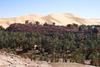 Mountains of sand loom over the oasis village of Taghit in the Sahara.