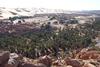 The oasis village of Taghit in the Sahara is known for its surrounding massive dunes. The oasis waters may be seen in the foreground. The site is southwest of Algiers, about 200 km (120 mi) from Beni Abbes.
