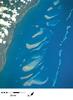 A closer view of some of the northern reefs in the Great Barrier Reef where the continental shelf is relatively narrow and the reefs closer to shore. Image courtesy of NASA.