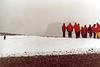 Mid-summer (22 December) on the Antarctic shore: humans huddle against the elements, penguin basks in the "balmy" weather.