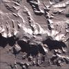 Vinson Massif is the tallest mountain in Antarctica. Its peak reaches 4,897 m (16,067 ft), though the mountain itself is a large raised feature around 21 km (13 mi) long and 13 km (8 mi) wide, dominating the Sentinel Range of the Ellesworth Mountains in which it is located. Image courtesy of NASA.