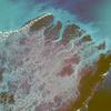 Infrared film helps accentuate plant growth and sediment accumulations in this near-vertical photograph of the numerous mouths of the Irrawaddy River in western Burma. The Irrawaddy Delta, one of the world's great rice-producing regions, consists of fertile river mud and sand deposited during the last 2 million years. The deep reds and violets at the southern end of the multichanneled delta (top of photo) reflect large mangrove forests. The light blues show the sediment plumes within the stream channels extending southward into the Andaman Sea. Image courtesy of NASA.