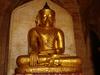 A golden Buddha statue sits in one of Bagan&apos;s many pagodas.