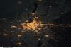 A night view of the Montreal metropolitan area is featured in this image from the International Space Station. This photo of the Montreal, Quebec metropolitan area (center) illustrates the extent of urbanization made clearly visible by city lights at night. Major roadways and industrial areas are traced by bright white lighting, while the adjacent residential and commercial land uses are characterized by more diffuse yellow-gold lighting. Rivers and other water bodies appear black, while the surrounding rural countryside is faintly illuminated by moonlight. Blurry areas at top and bottom left are caused by cloud cover. Montreal is the largest city in the dominantly French-speaking province of Quebec, and the second-largest in Canada, after Toronto. While the city of Montreal proper is located on - and almost completely covers - the Island of Montreal at the confluence of the St. Lawrence (center) and Ottawa Rivers (not visible), the city takes its name from Mont Royal located at the city's center. Image courtesy of NASA.