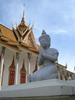Kneeling figure beside the Silver Pagoda at the Royal Palace grounds in Phnom Penh. The Silver Pagoda lies on the south side of the palace complex. The main building houses many national treasures, including gold and jeweled Buddha statues. 
