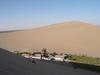 Crescent Moon Lake is an oasis in the Singing Sands Mountains, six kilometers south of Dunhuang. The lake gets its name from its shape. Activities in this area include camel riding, dune paragliding, and sand sledding. Most tourists visit in the evening to avoid the heat.