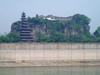 Shibaozhai is a steep, rocky, and craggy hill on the bank of the Yangtze River, in Zhong county, Chongqing. A temple at the crest of the 220 m (722 ft) hill was built in the 18th century. A nine-story wooden pagoda was constructed in the 1819 to aid pilgrims in getting to the top of the hill. In 1956, three more stories were added. A coffer dam protects the site from higher river waters - the result of the Three Gorges Dam.