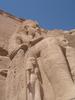 A closer view of one of the statues of Ramses at Abu Simbel shows Nefertari, his wife, at his knee.