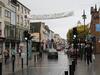 Street view of Killarney, County Kerry. Killarney is one of the principal towns in the country and a center of tourism for the region. The sign over the street reads "A Hundred Thousand Welcomes" (Cead Mille Failte).