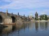 A riverside view of Charles Bridge in Prague showing the ice guards that protect the pillars. 