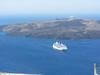 View of the 400 m (1300 ft)-deep volcanic caldera off the coast of Santorini/Thera Island. In the foreground is the island of Nea Kameni. In the background is the island of Therasia. Santorini, Nea Kameni, and Therasia were separated by a volcanic eruption termed the Minoan Eruption in about 1630 B.C.