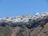 Houses and hotels perched on top of 300 m (980 ft) cliffs on Santorini/Thera Island. The cliffs show the many layers of volcanic eruptions over time.
