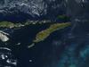 Southeast of the island of Timor (center), a phytoplankton bloom is coloring the waters of the Timor Sea, which separates Timor from northwestern Australia. To the north of Timor is Flores, which is home to numerous active volcanoes. (The red dots are due to fire, not volcanic activity.) The eastern half of Timor, as well as an exclave to the west and a few offshore islands, constitute the country of Timor-Leste. The western portion of Timor and the remaining islands (including Flores) belong to Indonesia. Image courtesy of NASA.